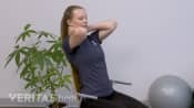 Woman doing a thoracic self extension mobilization.