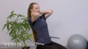 Woman doing a thoracic self extension mobilization.