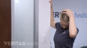 Woman doing a levator scapula stretch