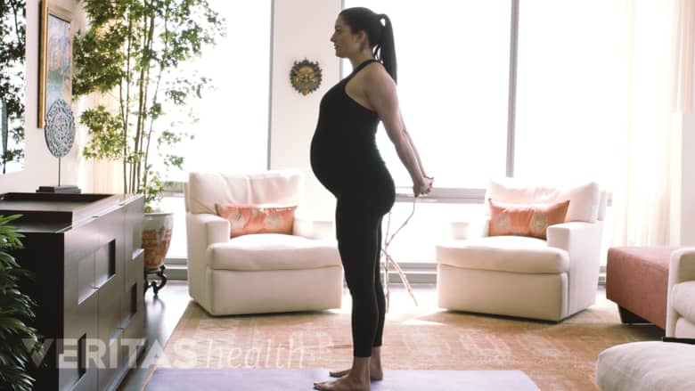 A pregnant woman showing chest stretch.