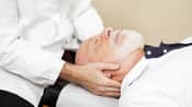 Chiropractor adjusting patient's neck