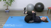 Woman doing a knee to chest stretch