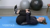 Women doing a knees to chest stretch