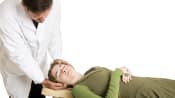 Patient receiving chiropractic adjustment of the neck