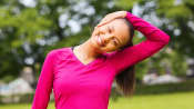 Woman stretching neck in the park