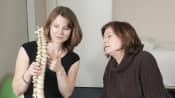 Physical therapist explaining the upper spine to a patient