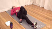 Woman doing the supine piriformis muscle stretch for sciatica pain relief