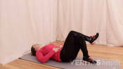 Woman lying on the floor doing the piriformis stretch