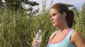 woman jogging with back pain outdoors