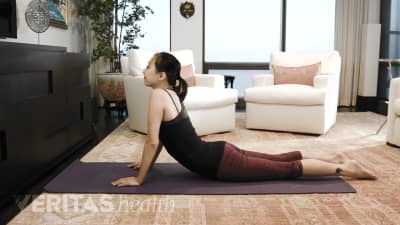 Woman doing cobra pose for upper and middle back pain