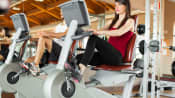 Woman riding a stationary bike at a gym