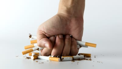 Fist smashing cigarettes.