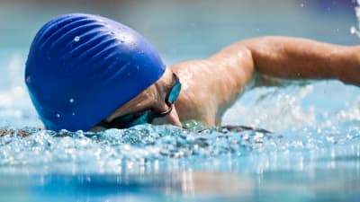 Man doing front stroke in the pool.