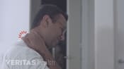 Man grabbing neck in pain