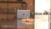 Man sitting at a table with his laptop