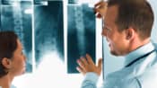 Doctor examining an X-ray of a patient's spine.