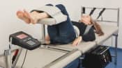 Patient lying prone receiving decompression therapy.