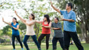 Group of people outdoors practicing Tai Chi.