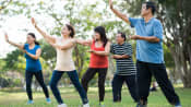 Group of people outdoors practicing Tai Chi.