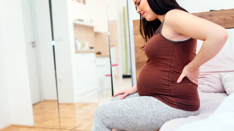 A pregnant woman having back aches.