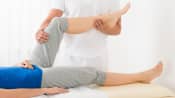 Physical therapist working with a patient's knee