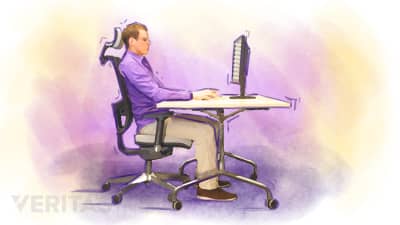 Man sitting in office chair which supports his neck