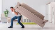 Man lifting a couch on his back
