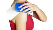 Woman icing her shoulder