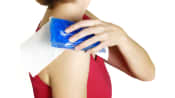 Woman icing her shoulder