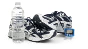 Pair of sneakers, pedometer and water bottle