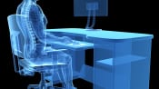 X-ray of person sitting at desk with proper posture