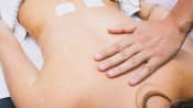 Tens unit being applied to the lower back.