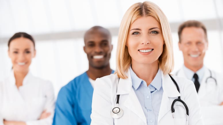 Four hospital professionals including a doctor in the forefront