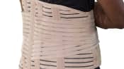 Man's torso with a lower back brace over his shirt