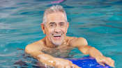 Man using a kickboard in the pool