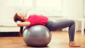 Woman doing a back bend over a large exercise ball