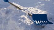 Snow shovel lying in the snow.