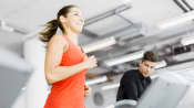 woman running on treadmill at the gym