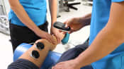 Cold Laser Therapy being performed on the leg