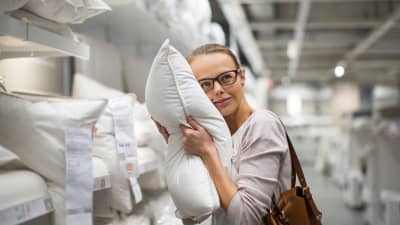Woman holding a pillow against her face