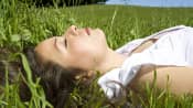 Woman lying down and resting in the grass