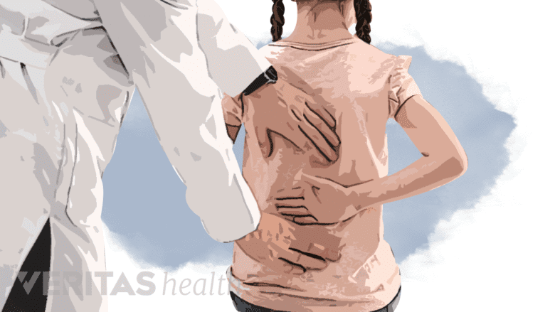 A doctor checking a child’s spine.