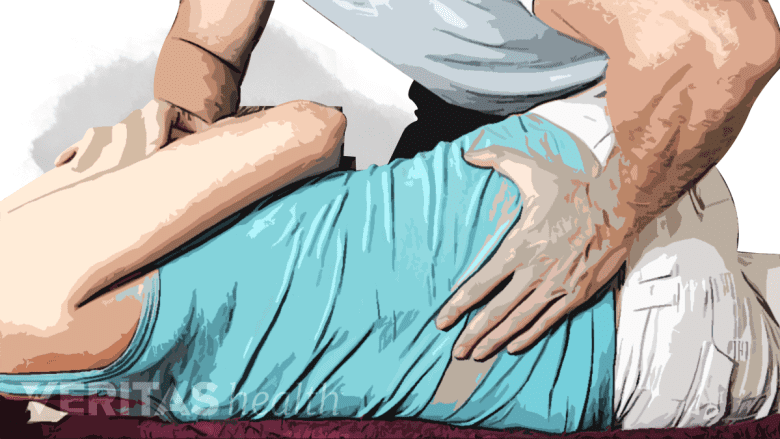 An illustration showing a therapist performing manual manipulation on a person.