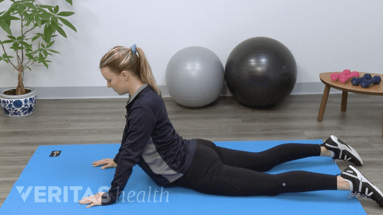 Therapist performing yoga for back pain.