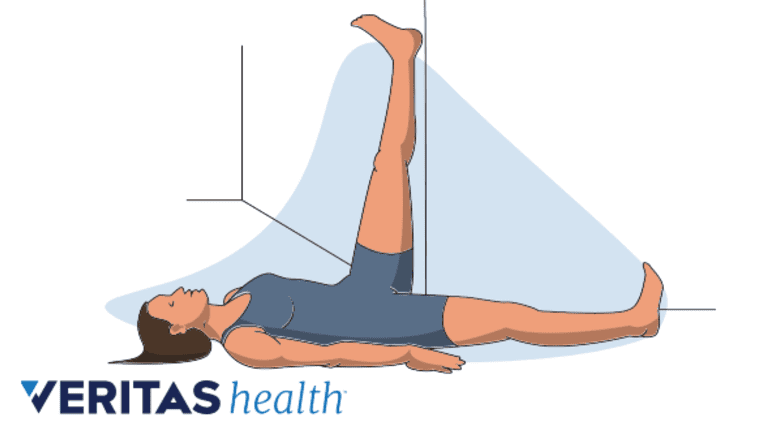 Woman doing a wall hamstring stretch.