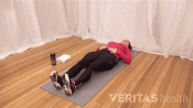 Woman lying on her back performing a piriformis muscle stretch