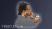 Profile view of a person swallowing pill