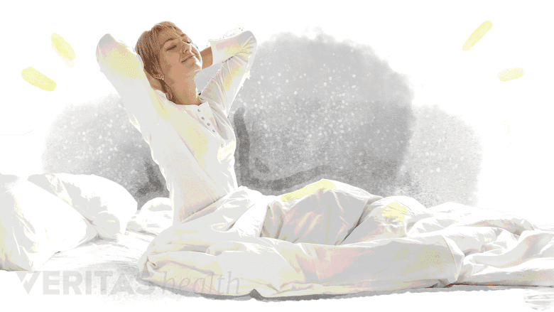 A woman waking up after resting.